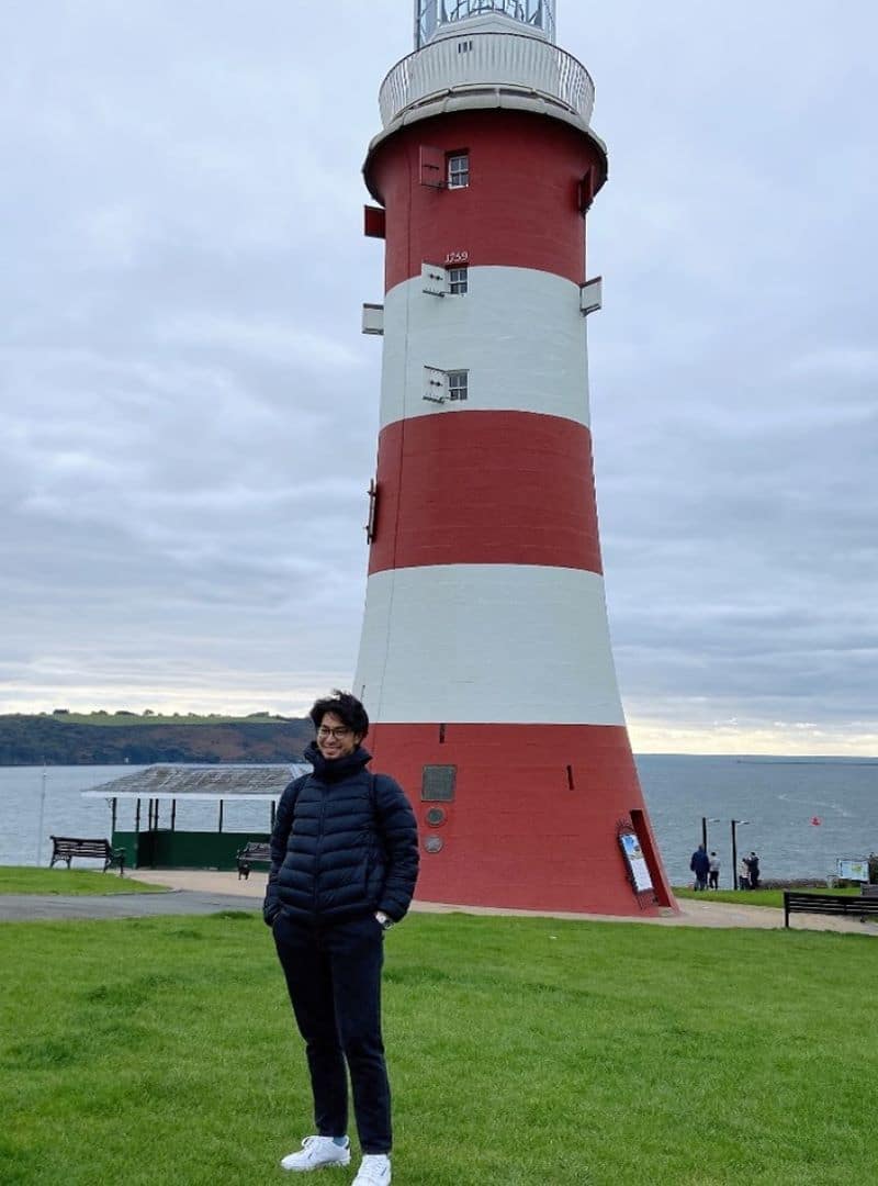 Student stood outside of light house